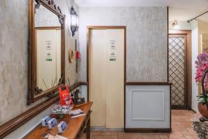 a bathroom with a mirror and a wooden table at Hotel Il Convento in Naples