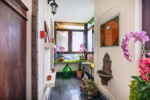 a hallway with potted plants and a window at Hotel Il Convento in Naples