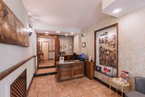 a hallway with a office with a desk in a room at Hotel Il Convento in Naples