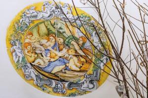 a painting of people on a yellow plate at Hotel Il Convento in Naples