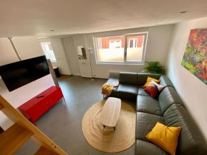 a living room with a couch and a table at Chez Marcel - Maison agréable in Dunkerque