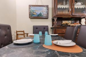 a dining room with a table with plates on it at Hotel Il Convento in Naples