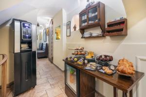 a kitchen with a counter with food and a refrigerator at Hotel Il Convento in Naples