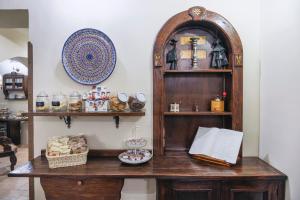 a room with a wooden table and a shelf with items at Hotel Il Convento in Naples