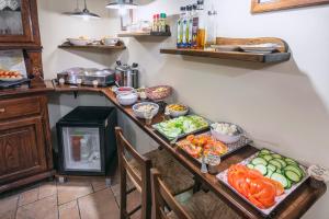 a kitchen with a table with vegetables on it at Hotel Il Convento in Naples