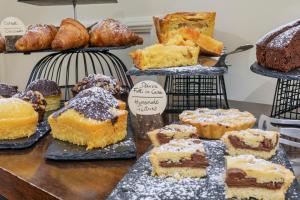a display of different types of cakes and pastries at Hotel Il Convento in Naples