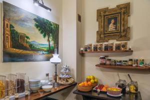 a room with a table with food and a painting on the wall at Hotel Il Convento in Naples