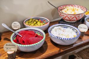 a group of bowls of food on a wooden table at Hotel Il Convento in Naples