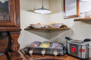 a kitchen with a counter with bread and a toaster at Hotel Il Convento in Naples
