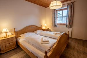 a bedroom with a bed and two lamps and a window at Haus 34 Top 1 in Krimml