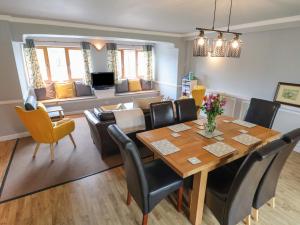 a dining room and living room with a table and chairs at The Barn The Elms in Telford