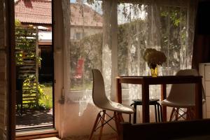 a table and two chairs in front of a window at DeBoskie Domki in Mrągowo