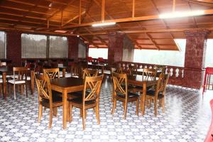 a dining room with wooden tables and chairs at Kanasu Serenity in Gokarna