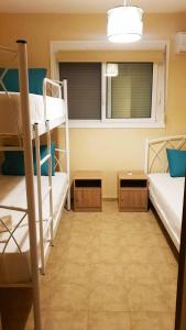 a room with two bunk beds and a window at IKIES LUXURY MAISONETTE HALKIDIKI Psakoudia in Psakoudia