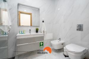 a bathroom with a sink and a toilet and a mirror at #233 Fox Trail by Home Holidays in Páteo