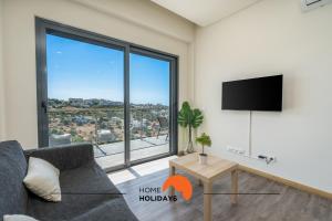 a living room with a couch and a large window at #233 Fox Trail by Home Holidays in Páteo