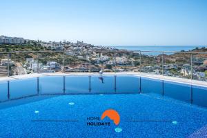 a swimming pool with a view of the ocean at #233 Fox Trail by Home Holidays in Páteo