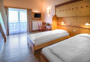 Rúm í herbergi á JUFA Hotel Gitschtal