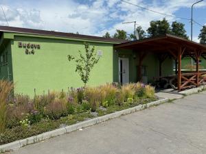 a green building with flowers in front of it at Ubytování ProDante in Ostrava
