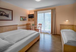 Rúm í herbergi á JUFA Hotel Gitschtal