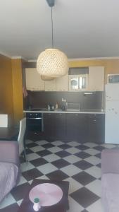 a kitchen with a checkered floor in a living room at Golden Hacienda in Sozopol