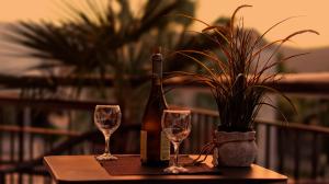 a bottle of wine and two glasses on a table at Amalia in Stavros