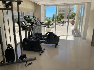 a gym with a treadmill and a exercise bike at Hotel Santamarta in Cullera