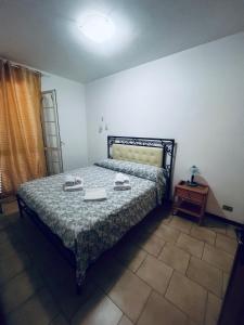 a bedroom with a bed and a table with a lamp at Villa Lucia in Sabaudia
