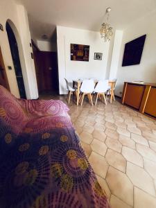 a bedroom with a table and chairs and a bed at Villa Lucia in Sabaudia