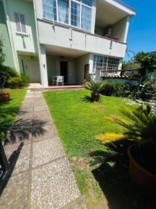 a house with a lawn in front of it at Villa Lucia in Sabaudia