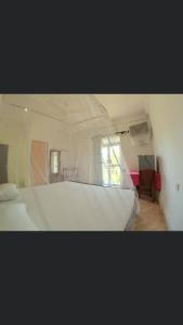 a bedroom with a white bed and a window at Blue Ocean Hotel in Matara