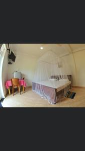 a room with a bed with a net over it at Blue Ocean Hotel in Matara