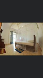 a bedroom with a large white bed in a room at Blue Ocean Hotel in Matara