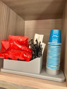 a shelf with a container of utensils and plates at Azzurra in Terrasini