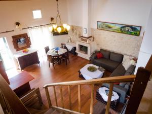 a living room with a couch and a fireplace at Olga's Home Oitylo in Oitylo