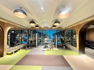 a gym with a view of the city at Masteri - Vinhome Grand Park - HELEN APARTMENT in Ho Chi Minh City