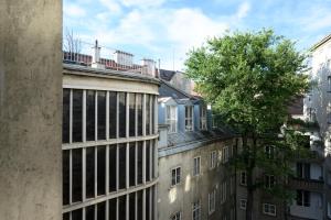 a tall building with a tree on top of it at Palais Palffy Suits in Vienna