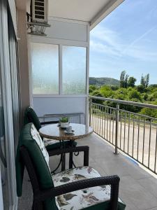 a balcony with a table and chairs and a view at Apartmani Pantovic - Apartman 2 in Trebinje