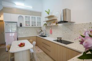 a kitchen with a counter and a table in it at Sophia Healing House Cần Thơ in Can Tho