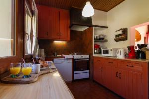 a kitchen with two glasses of orange juice on a counter at Chalet Dava La Via ski in - ski out - Happy Rentals in Chamonix-Mont-Blanc