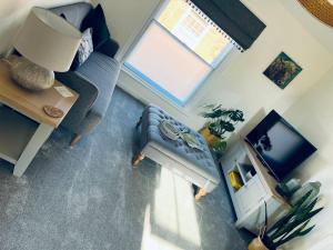 an overhead view of a living room with a couch and a television at Urban Stay Apartment in Aylsham