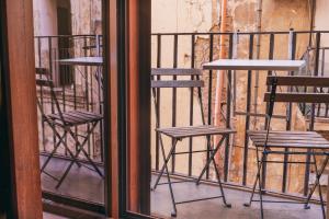 a group of chairs and tables on a balcony at Hotel Il Convento in Naples