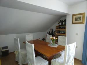 a dining room with a wooden table and chairs at Nika in Ogulin