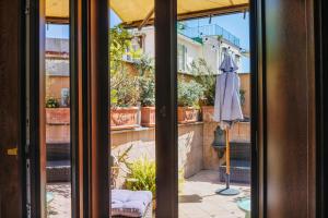 a sliding glass door with an umbrella outside at Hotel Il Convento in Naples
