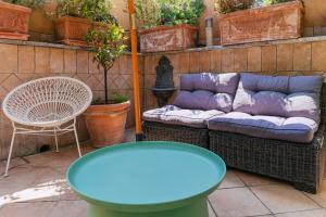 a couch and a table on a patio at Hotel Il Convento in Naples
