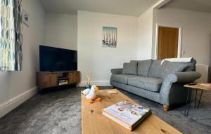 a living room with a couch and a table at Clock Tower Apartment No4 in Morecambe