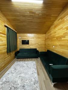 a living room with a couch and a tv at Adrasan yeşim apart evleri in Kumluca +8 photos