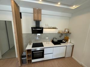 a small kitchen with a stove and a sink at Epicenter Suite in Trebinje