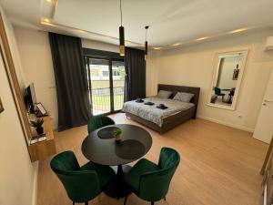 a living room with a bed and a table and chairs at Epicenter Suite in Trebinje +47 photos