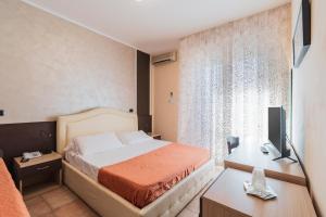 Postel nebo postele na pokoji v ubytování Hotel Gabrini